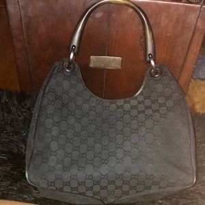 Gorgeous Gucci black GG canvas  bag with carved wood handle and whipstitch trim.